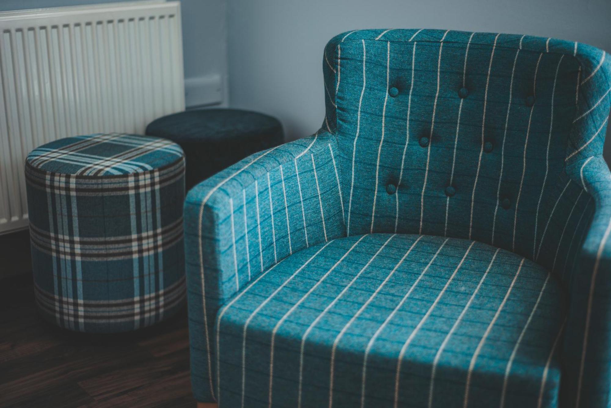 Oban Youth Hostel Экстерьер фото A chair and stool upholstered in tartan